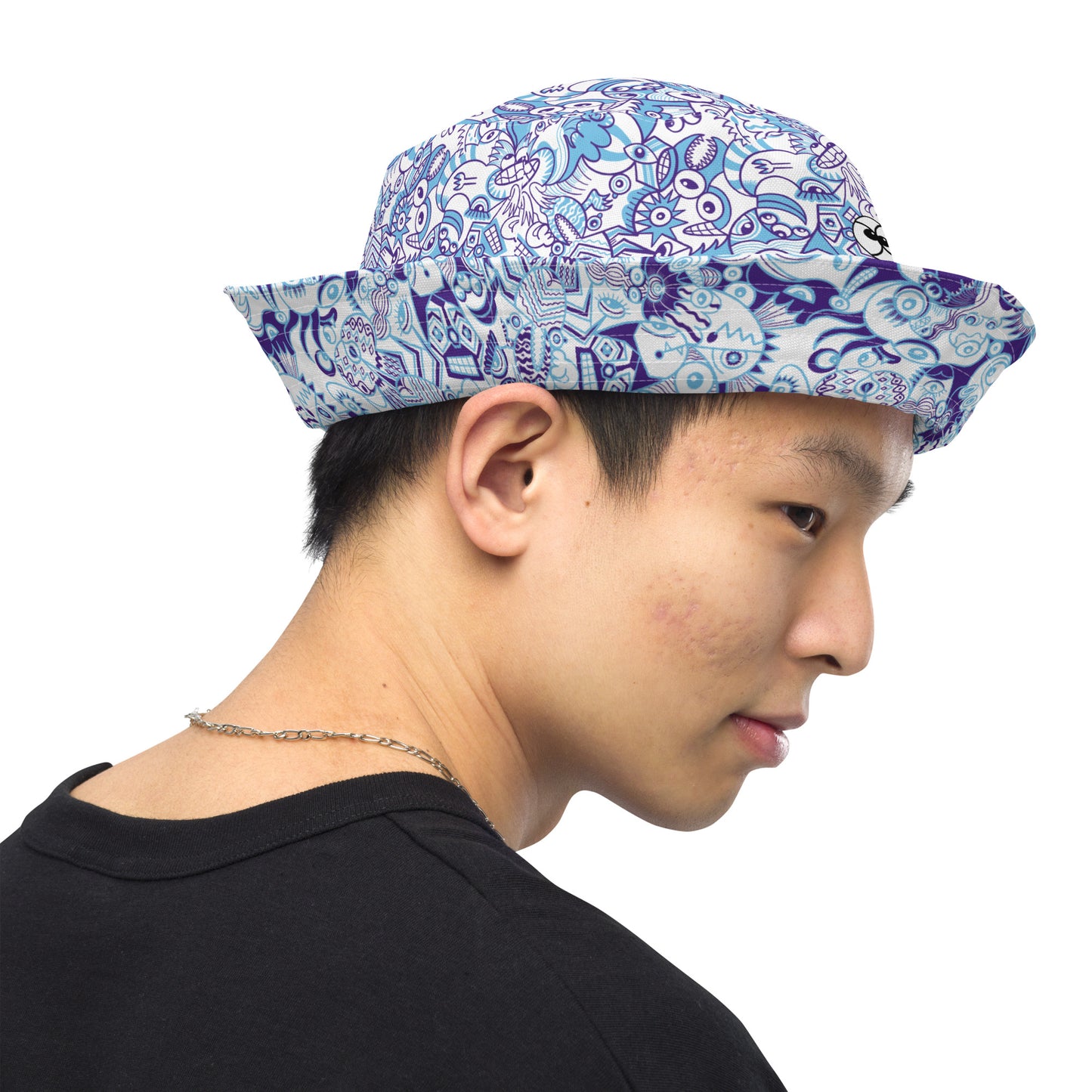 Whimsical Blue Doodle Critterscape pattern design Reversible bucket hat. Side view. Hat folded