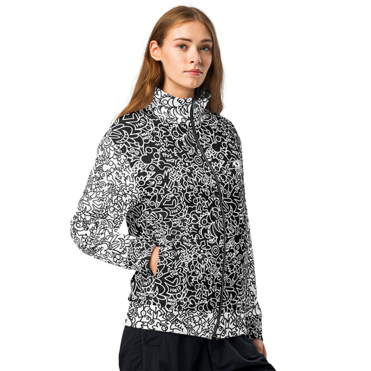 Woman modeling Playful Power of Great Doodles track jacket, showing the zip front and contrasting black-and-white doodles.
