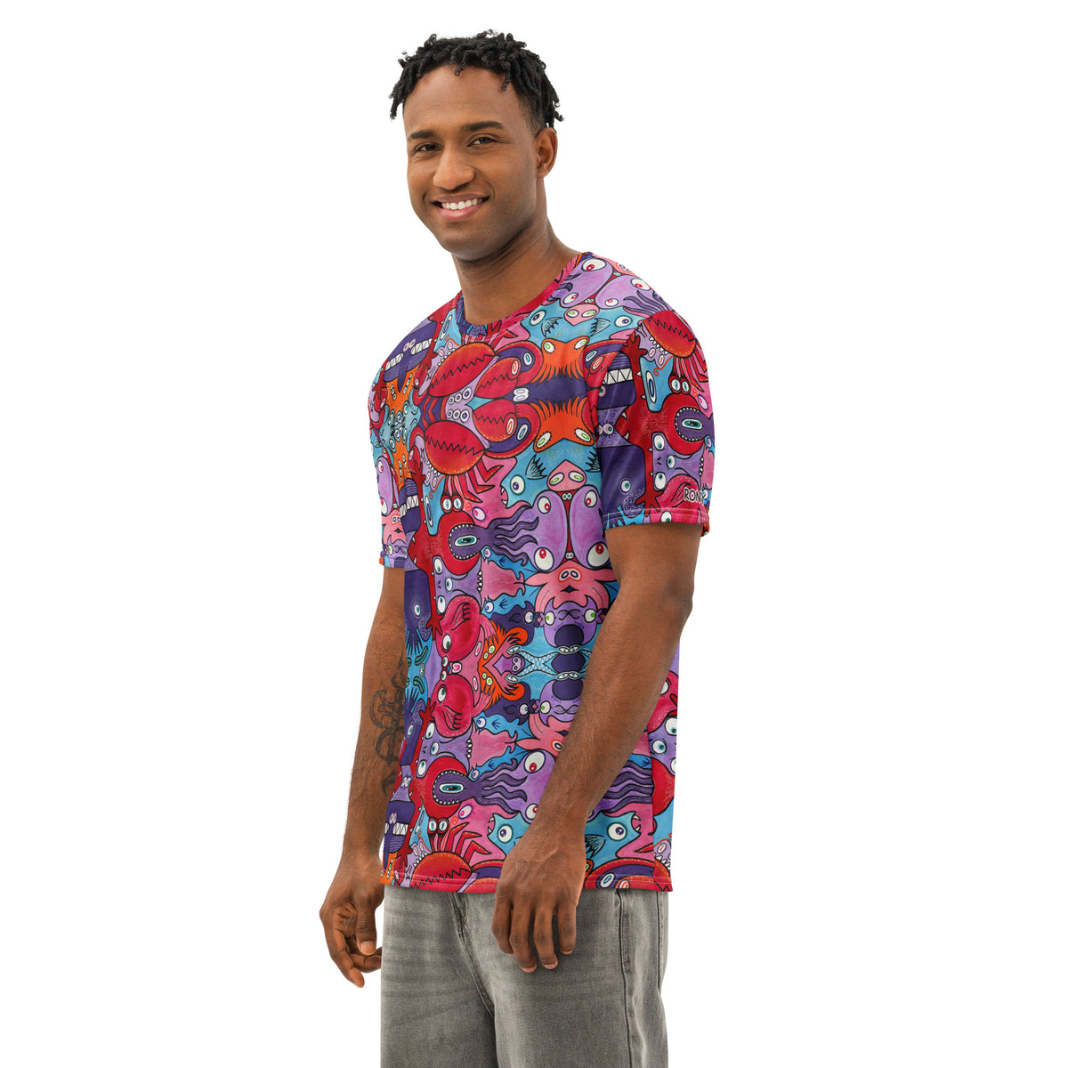 Man modeling Eyes See the Unseen psychedelic cotton t-shirt in three-quarter view, with colorful creature artwork.