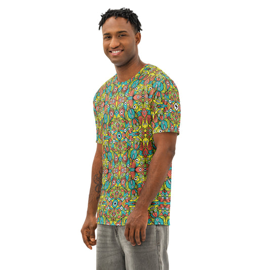 Man wearing Infinitely Playful Alien Monsters cotton t-shirt with colorful all-over creature print, front three-quarter view