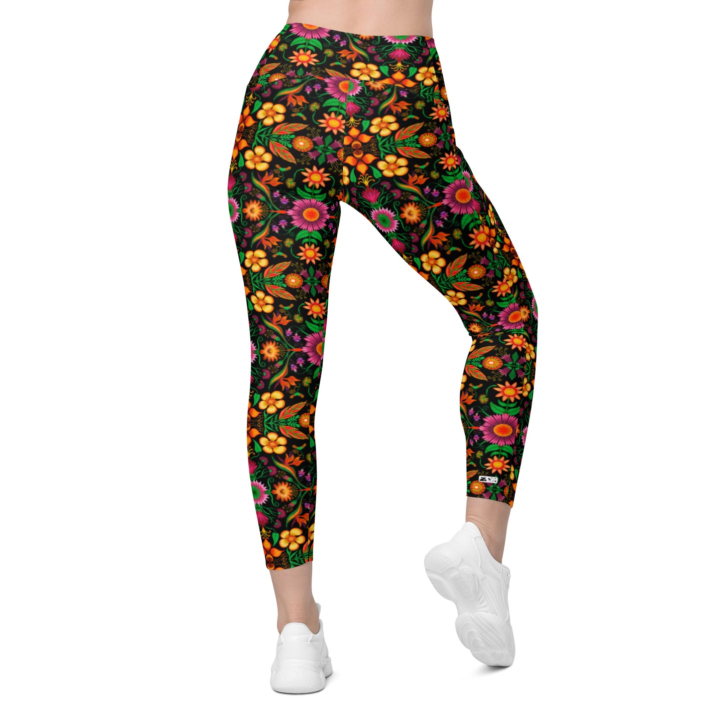 Wild flowers in a luxuriant jungle Crossover leggings with pockets. Back view