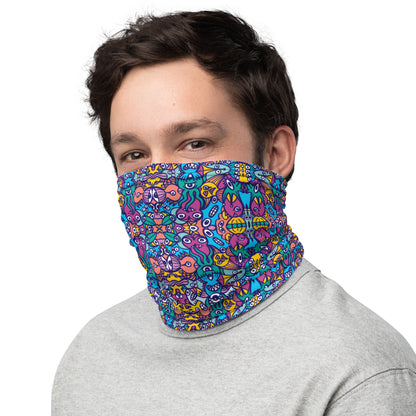 Smiling man wearing a Neck Gaiter all-over printed with Whimsical design featuring multicolor critters from another world
