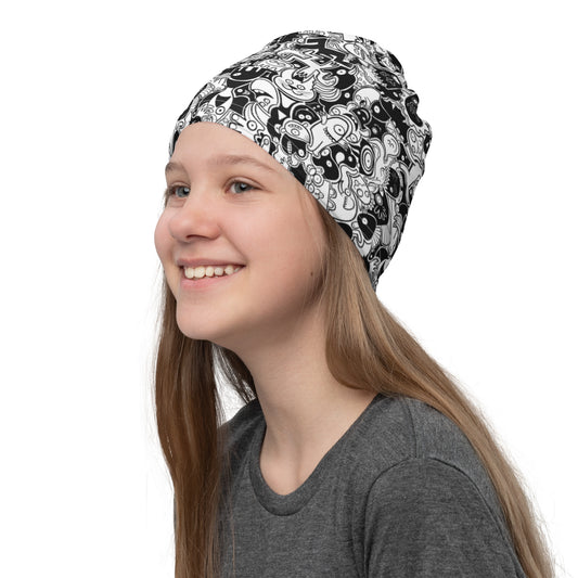 Smiling girl wearing Neck Gaiter All-over printed with Joyful crowd of black and white doodle creatures. Hat
