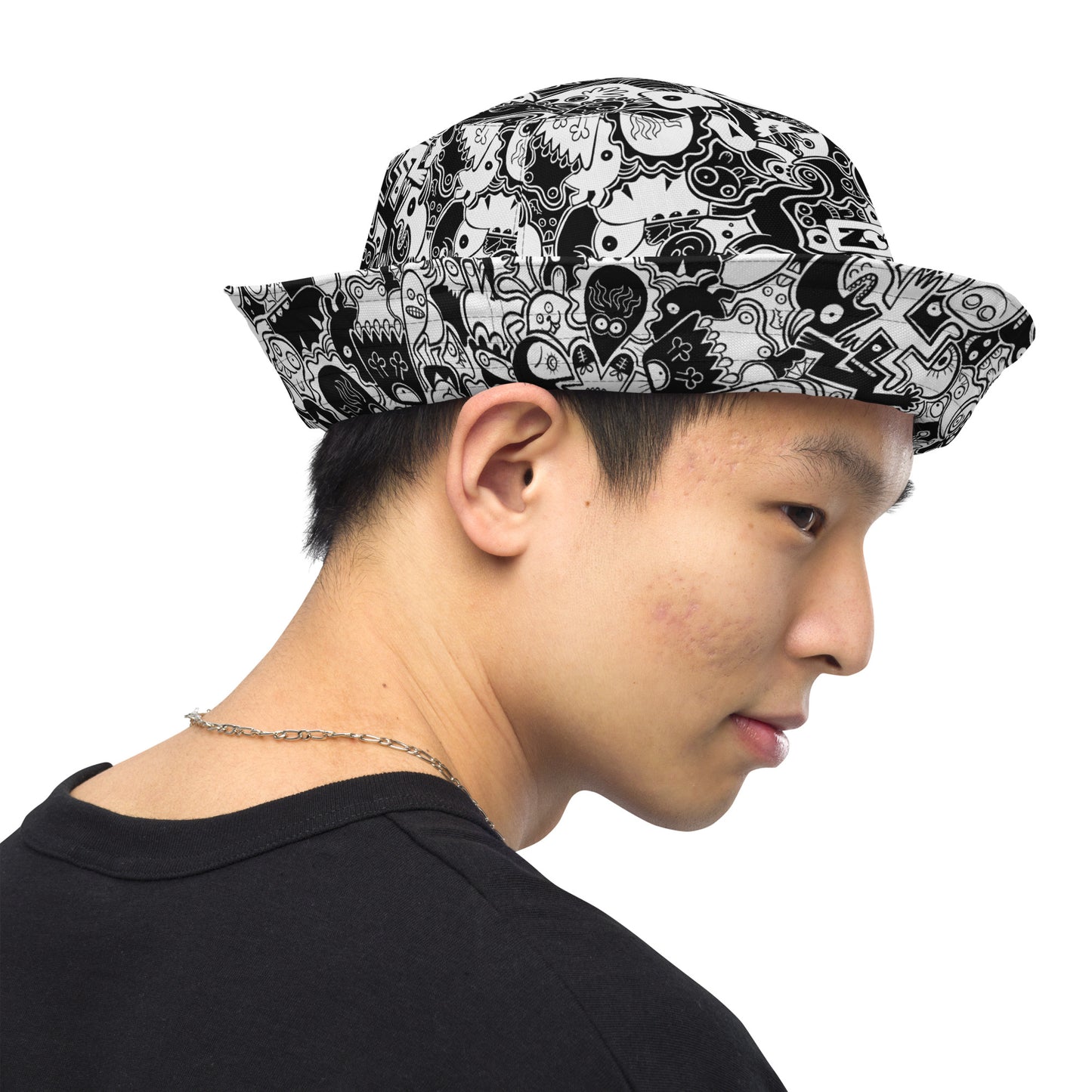 Joyful crowd of black and white doodle creatures Reversible bucket hat. Inside view