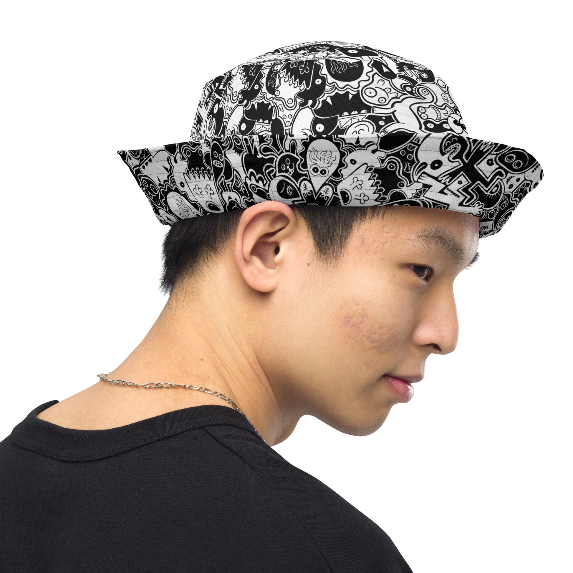 Joyful crowd of black and white doodle creatures Reversible bucket hat. Outside view