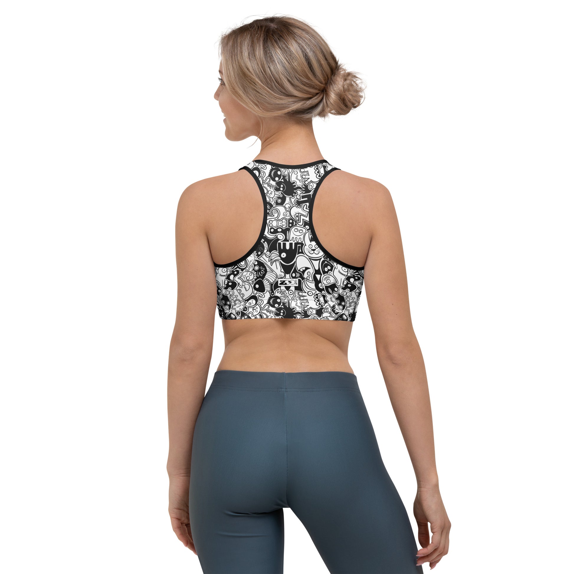 Joyful crowd of black and white doodle creatures Sports bra. Back view