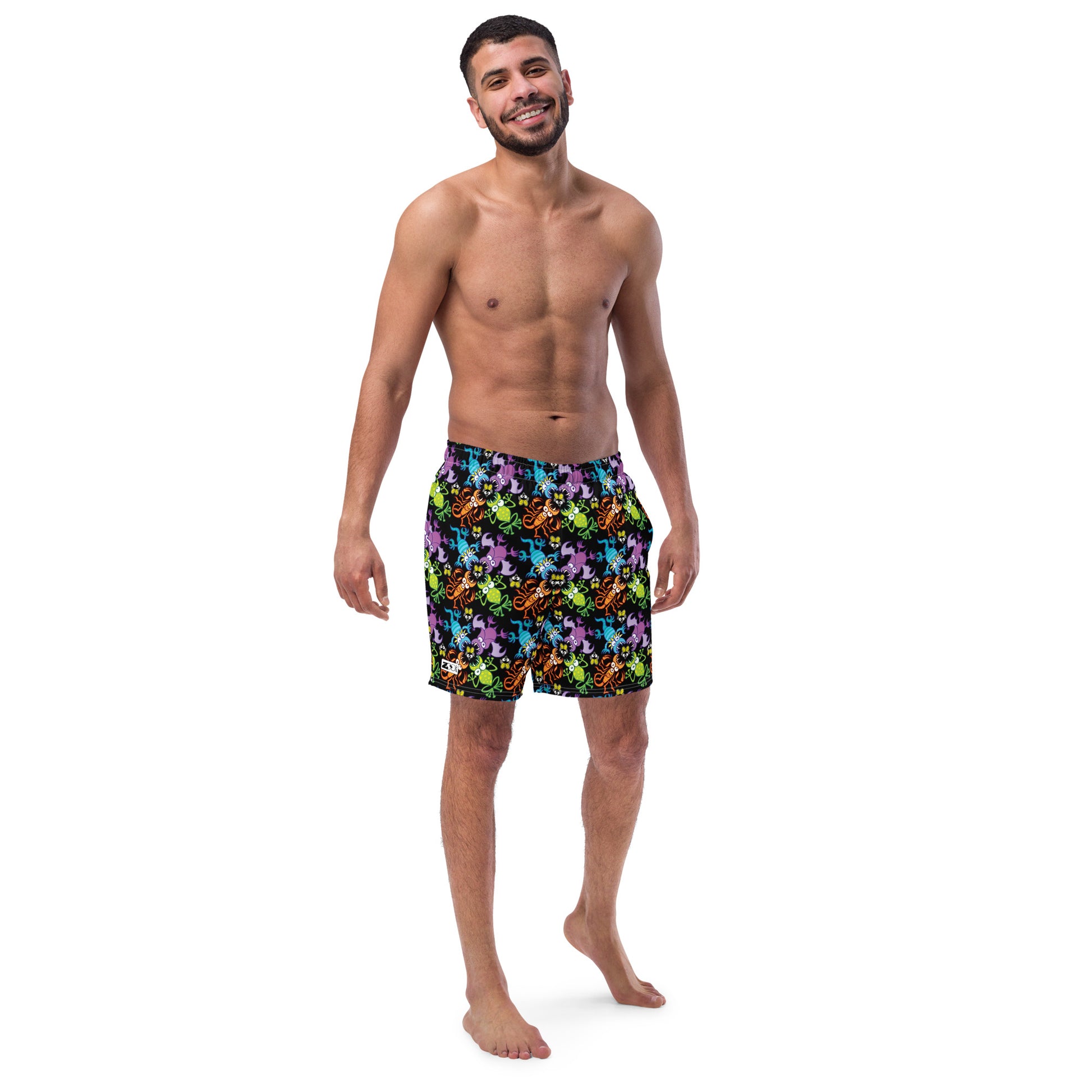 Smiling man wearing Swim Trunks All-over printed with Bat, scorpion, lizard and frog fighting over an unlucky fly
