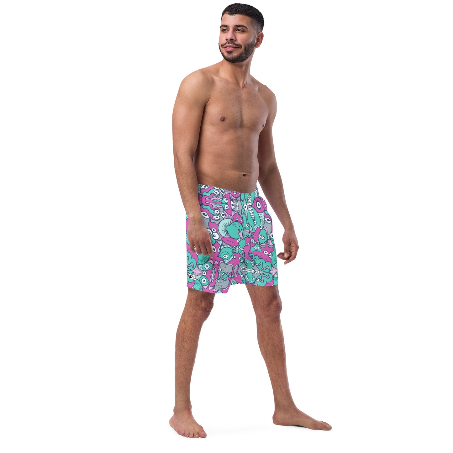 Smiling man wearing Men's swim trunks All-over printed with Sea creatures from an alien world