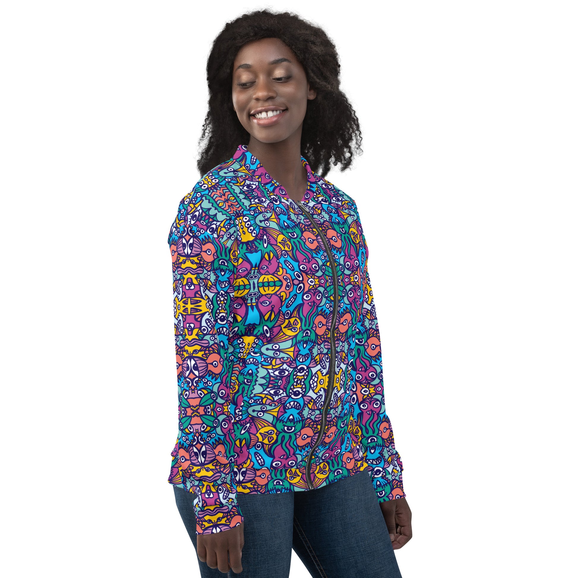 Smiling woman wearing Unisex Bomber Jacket All over printed with Whimsical design featuring multicolor critters from another world