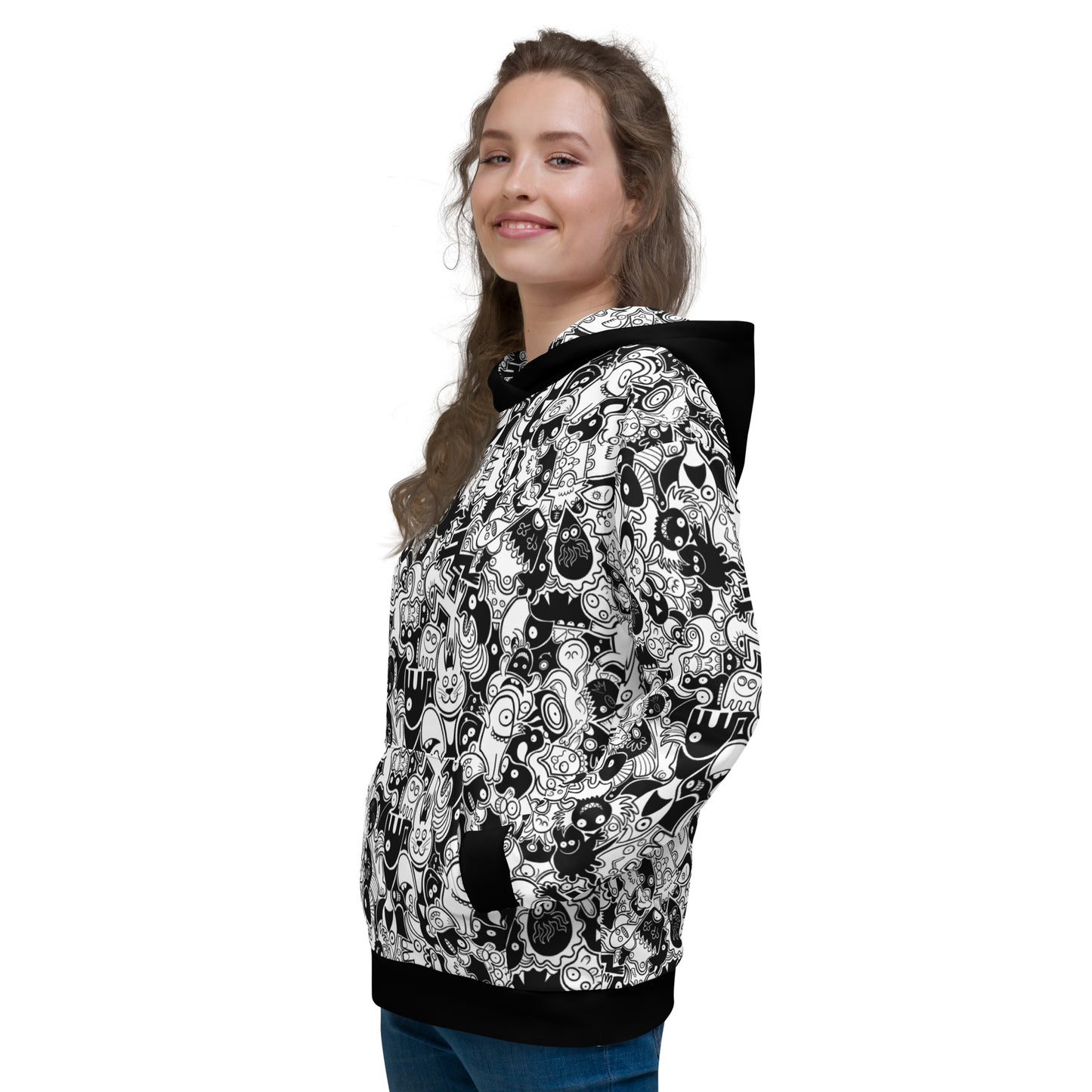Beautiful woman wearing Unisex Hoodie All-over printed with Joyful crowd of black and white doodle creatures