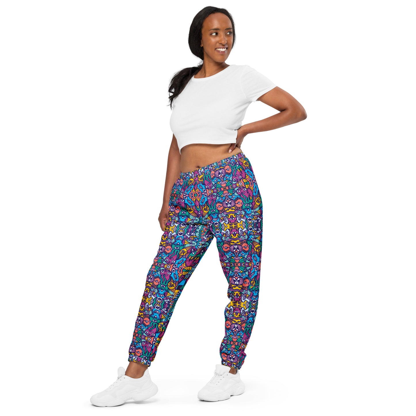 Whimsical design featuring multicolor critters from another world Unisex track pants. Front view