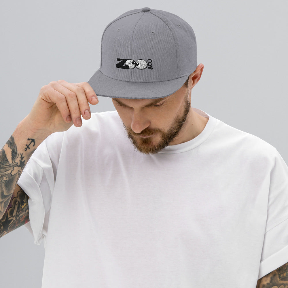Young man wearing a Zoo&co branded Snapback Hat. Silver