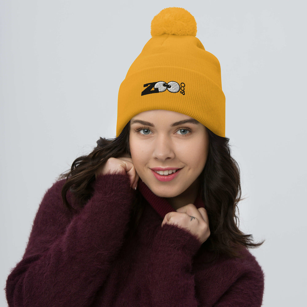 Zoo&co branded Pom-Pom Beanie. Fight the cold winter in style. Gold. Beautiful woman wearing Zoo&co's pom-pom beanie