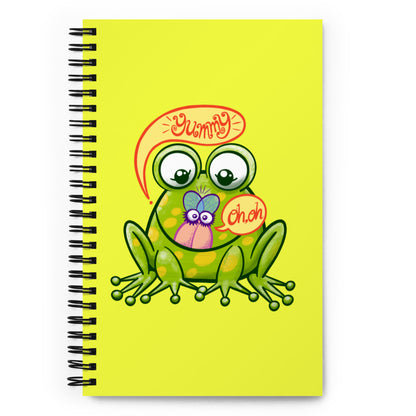 Mischievous frog hunting a delicious fly Spiral notebook. Front view