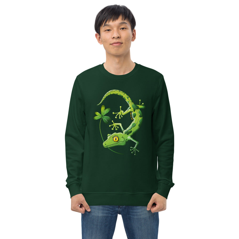 Smiling young man wearing Unisex organic sweatshirt printed with Saint Patrick’s Day Gecko holding a shamrock